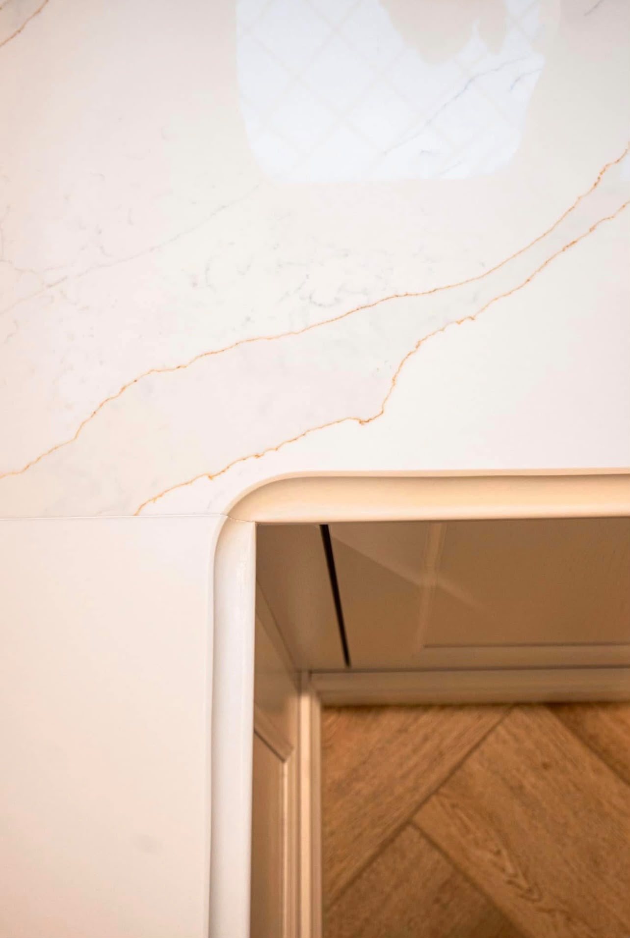 Close view of Calacatta Gold, a soft gold vein running across the polished surface