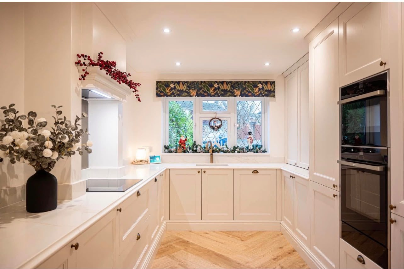 Cream in-frame kitchen with Calacatta Gold worktops, dressed for Christmas