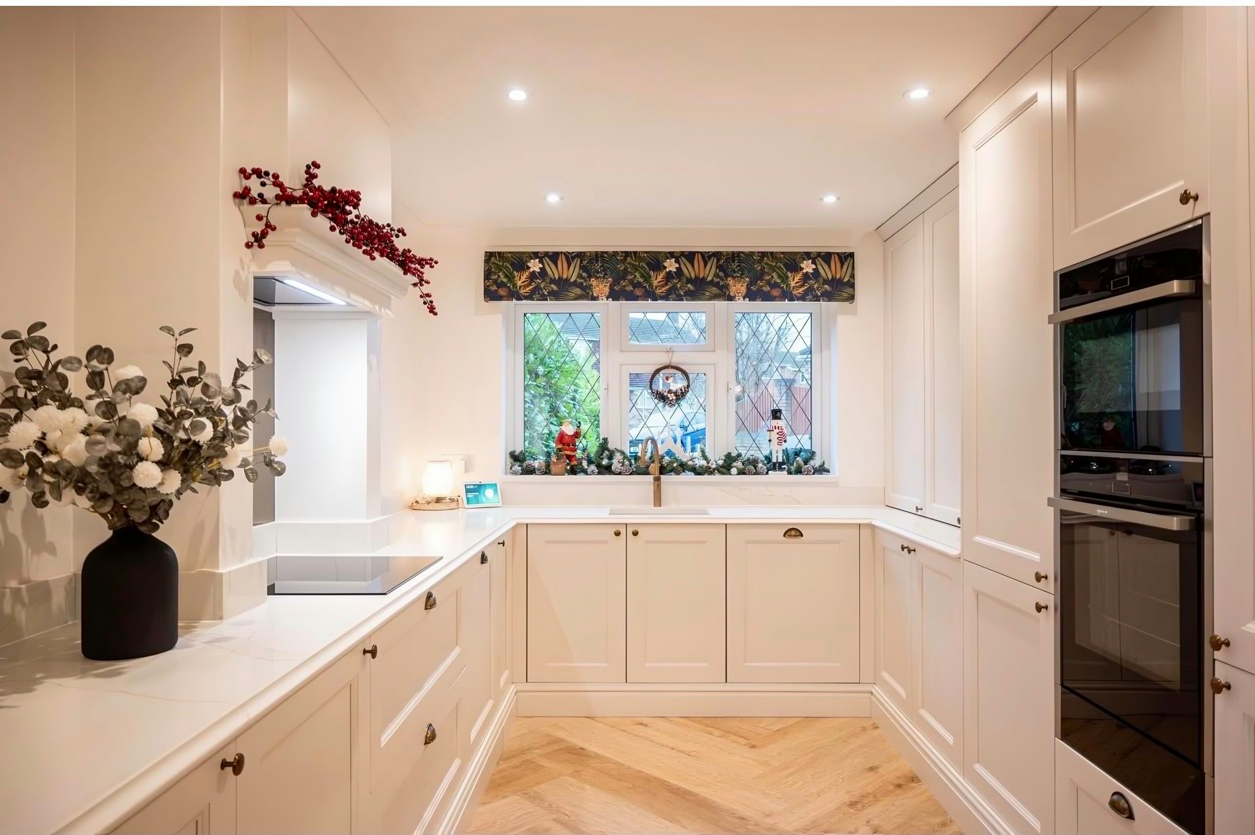 Cream in-frame kitchen with Calacatta Gold worktops, dressed for Christmas