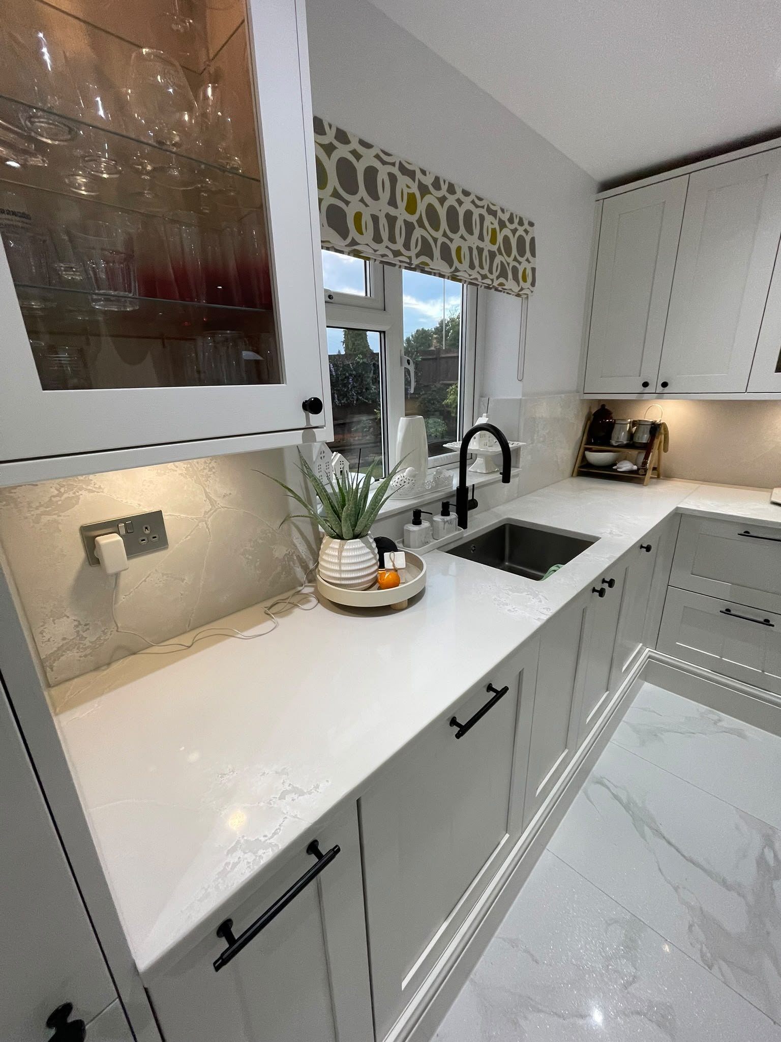 Polar White running down one side of the kitchen, past the sink to the far corner
