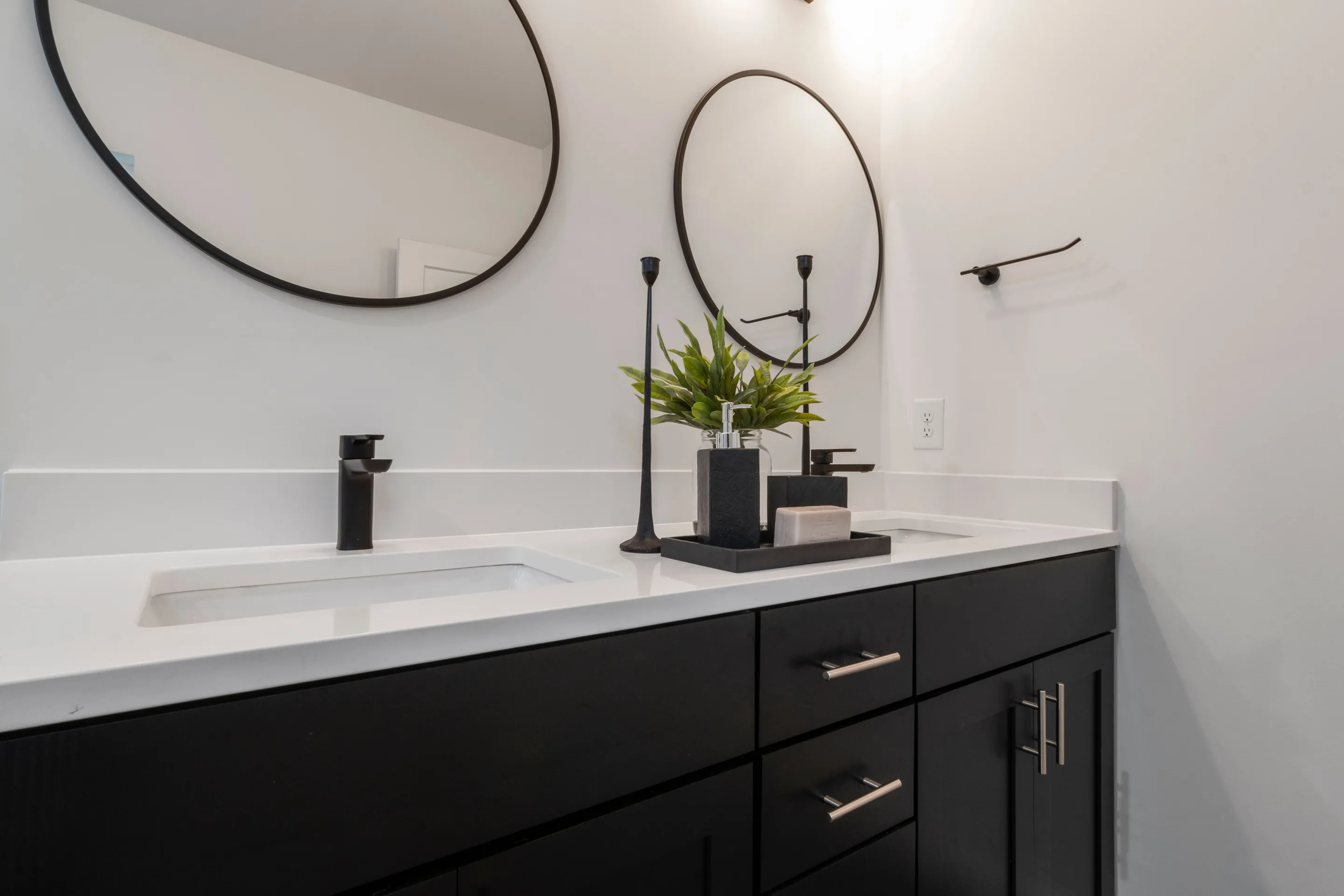 Sleek black and white bathroom vanity featuring double sinks and elegant design.
